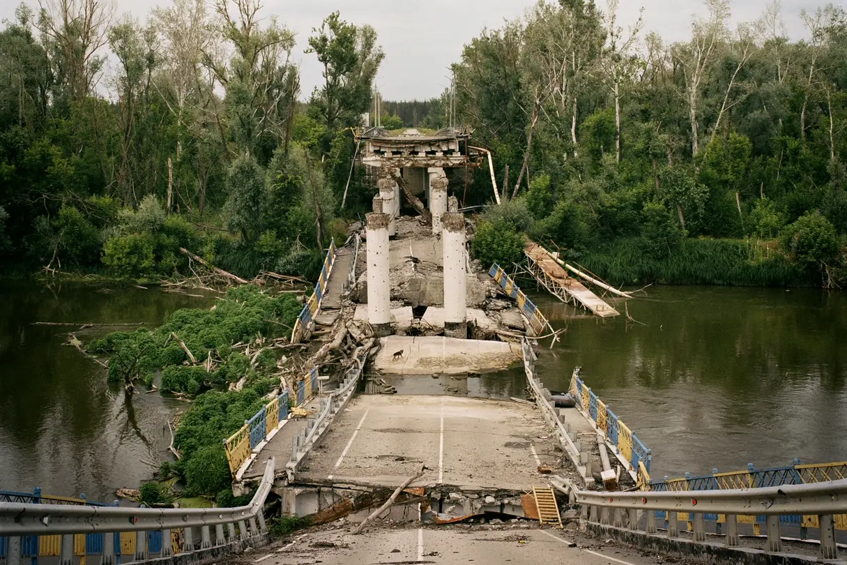 A collapsed bridge lies in the river.