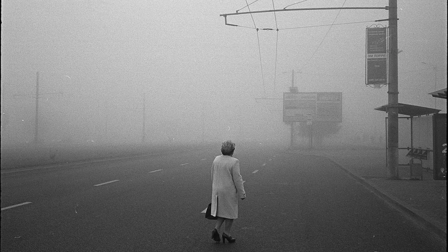Black and White photograph of a person in a foggy street