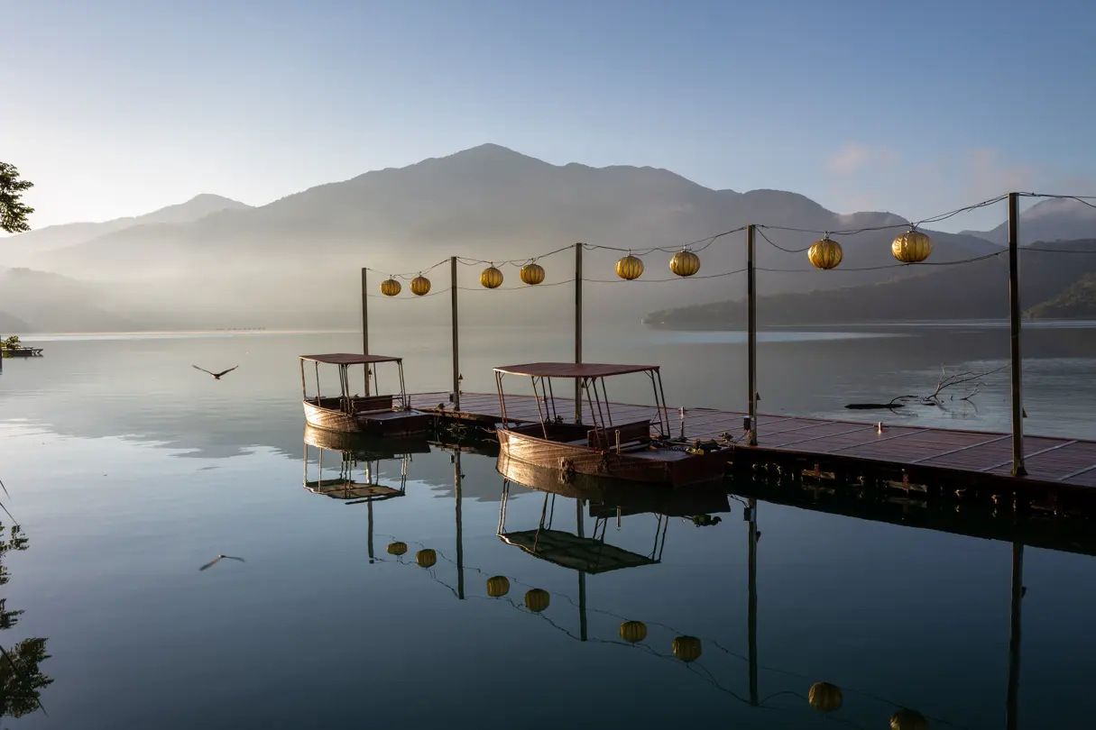 A lake with old boats at a jetty