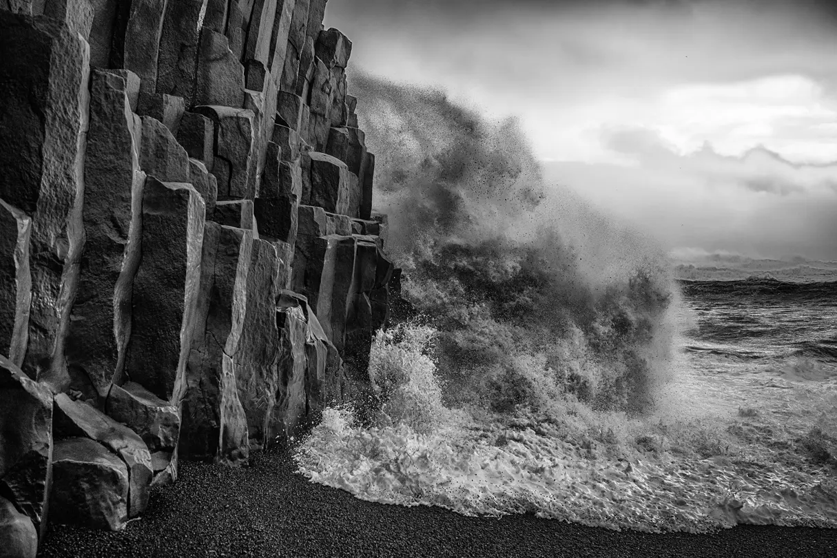 waves crashing into a cliff