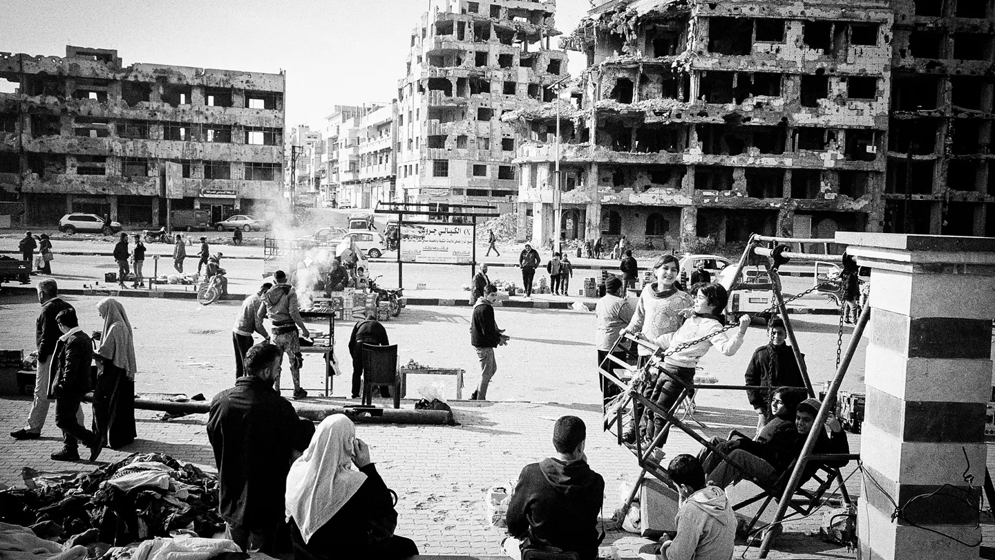 Syria after the fall of the regime in 2024. Many people in front of old ruins