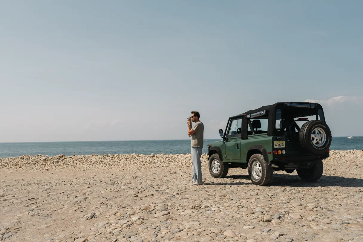 Riley with his car on the beach