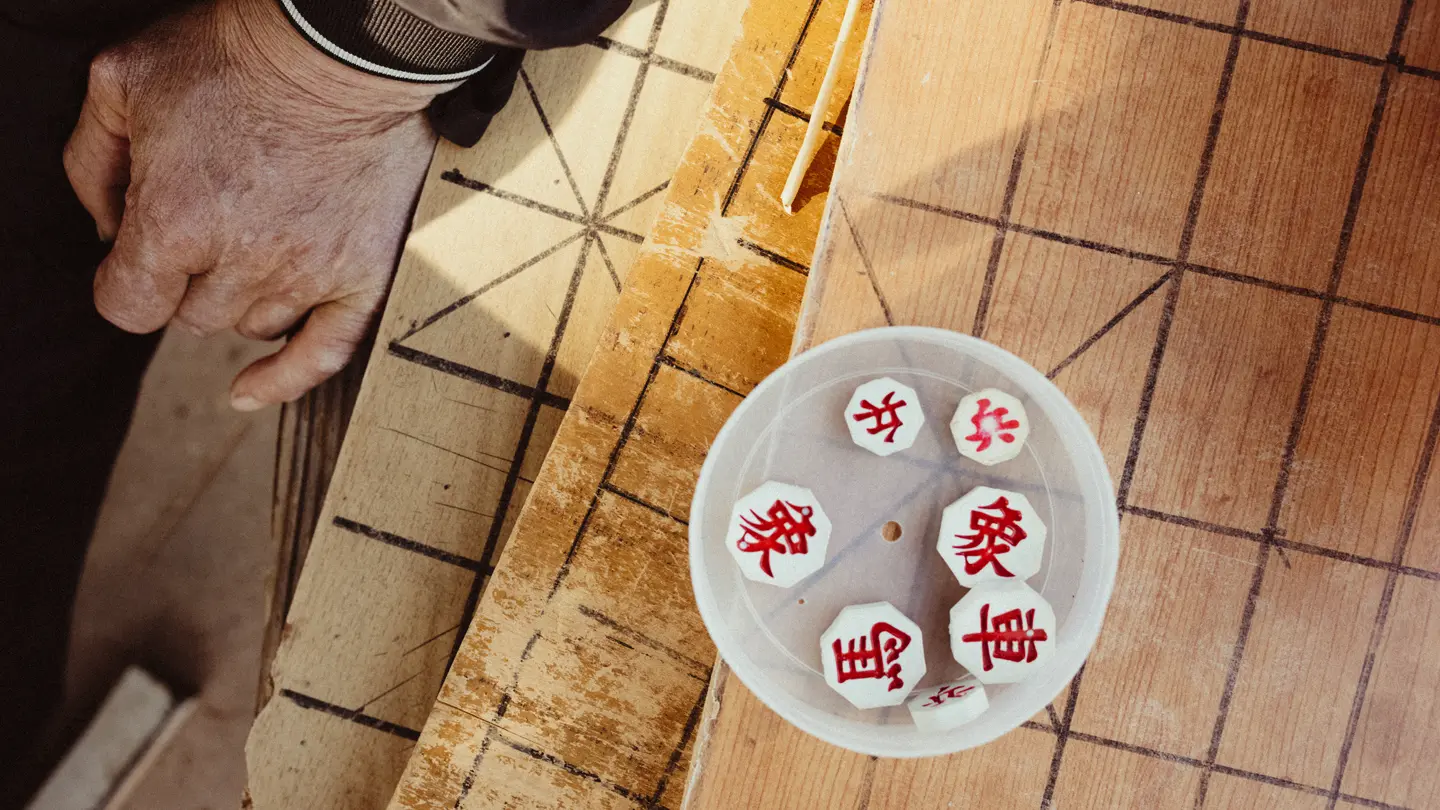 Main d'une personne et pièces d'un jeu 
