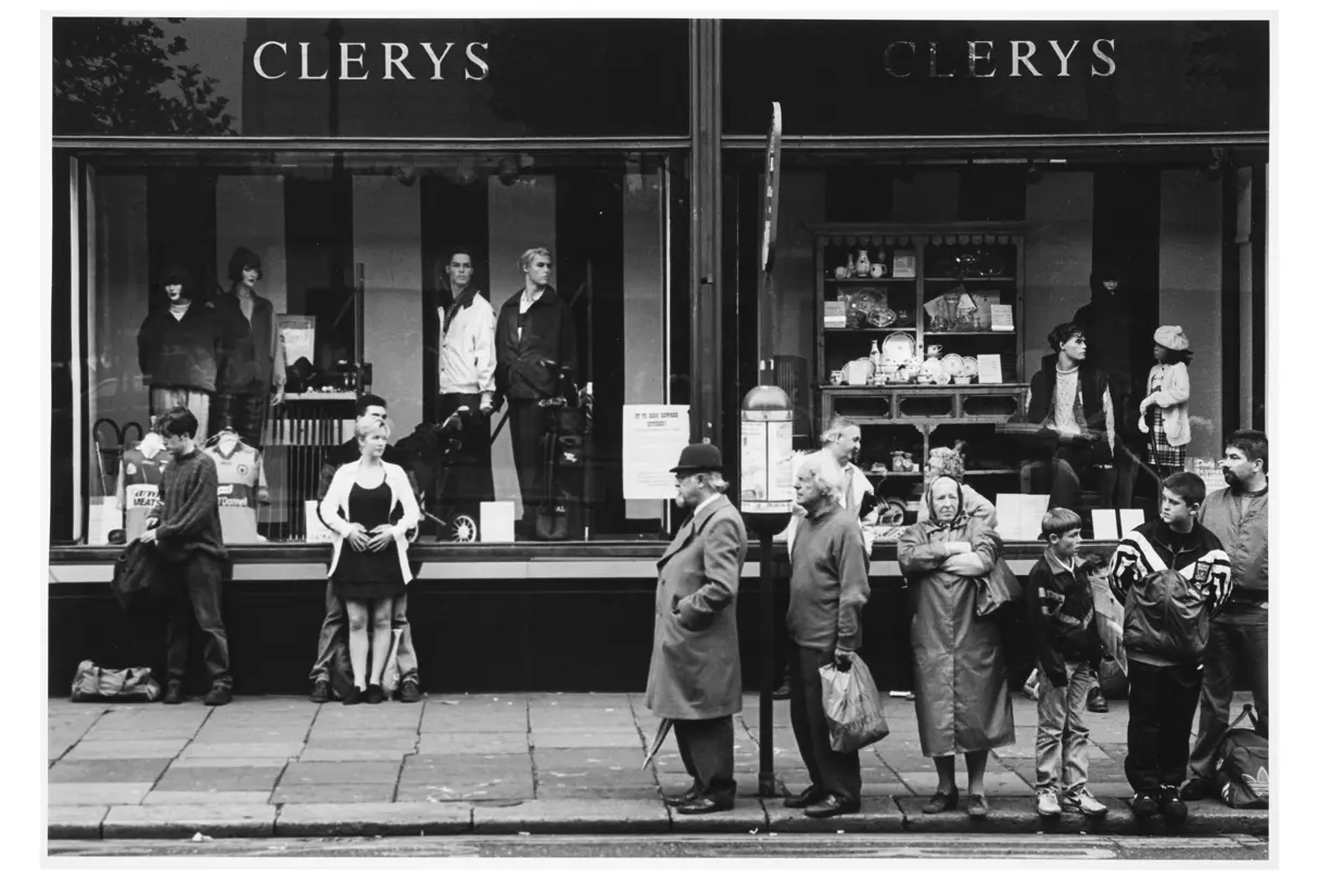 people waiting at a bus stop