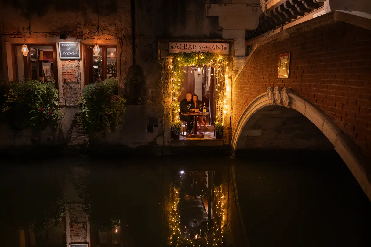 Lovers sitting in a small restaurant in Venice