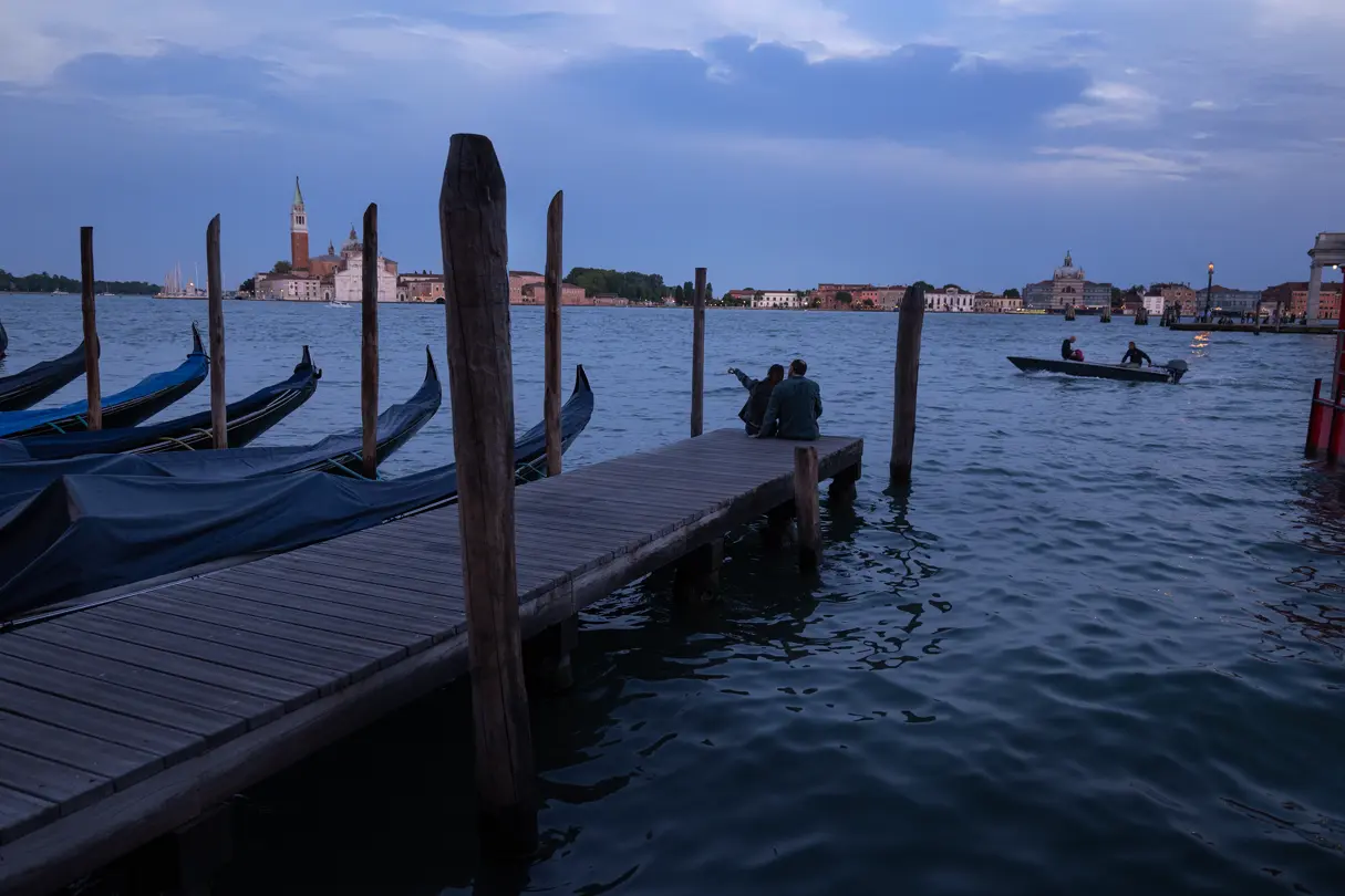 Lovers sitting on a jetty in Venice