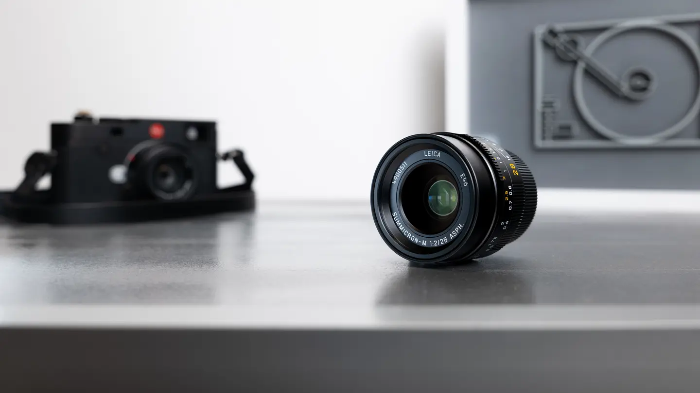 Summicron-M 28 f/2 ASPH. in the foreground and Leica M11 in the background