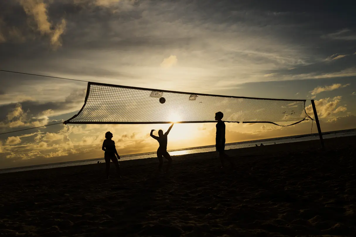 People playing volleyball in the beach