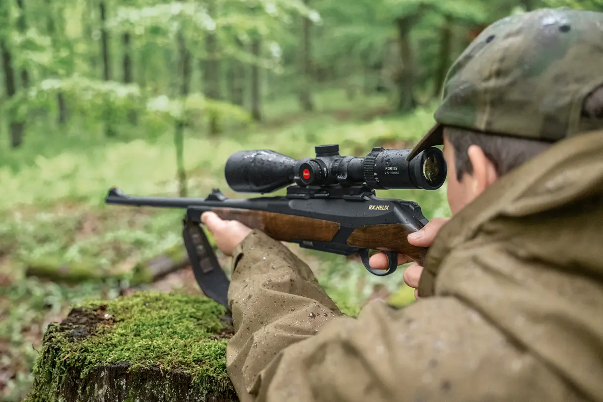 Hunter is aiming with his rifle and his Leica Fortis