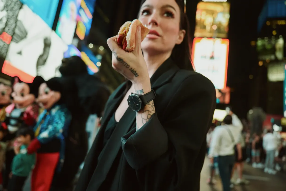 Mynxii White with a Leica ZM11 watch on his wrist and a hot dog