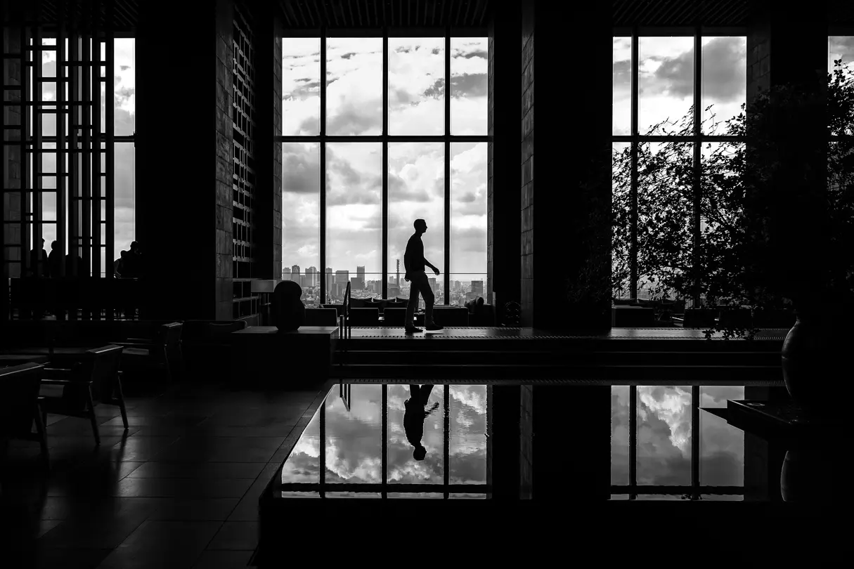 Black and white photography of an architectural building with a Man inside