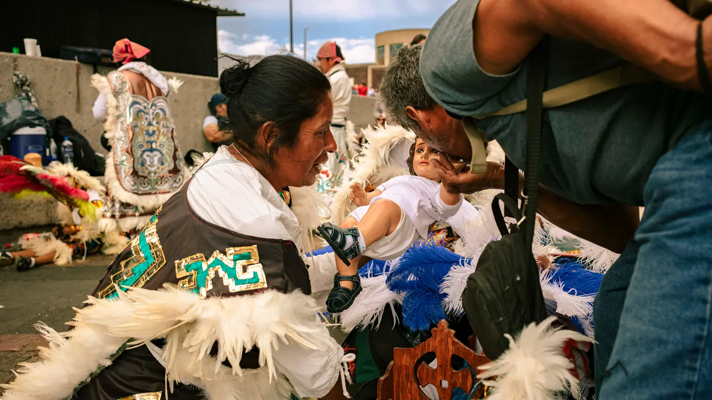 colour image of a man kissing a statues hand