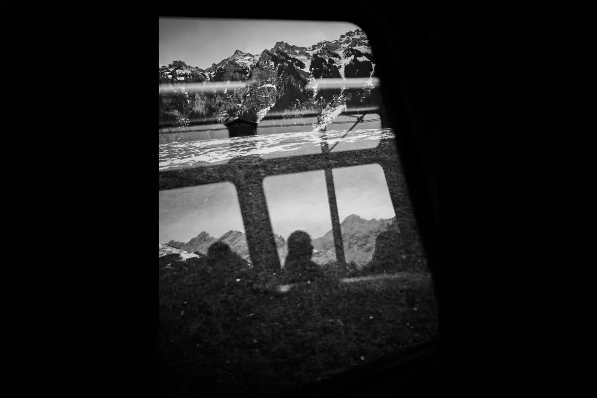 Black and white photo about a man in a train