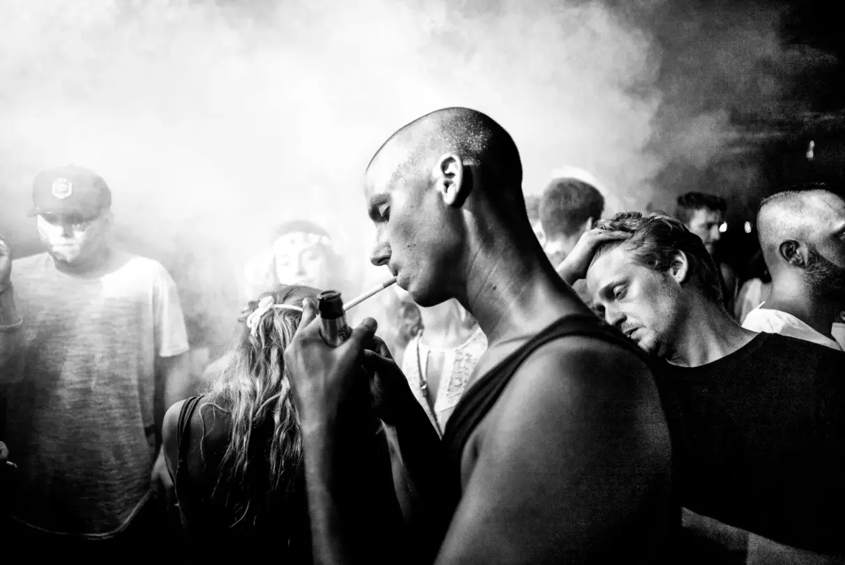 man smoking cigarette black and white