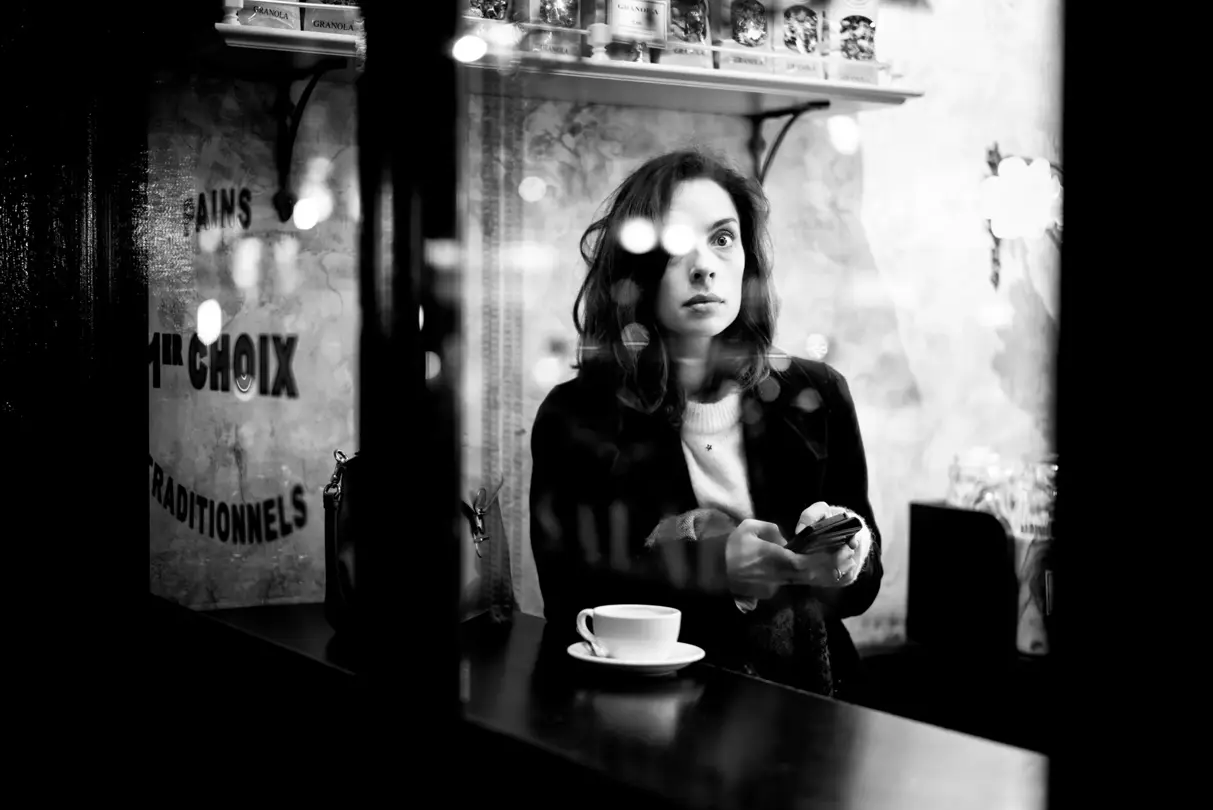 woman sitting in cafe black and white