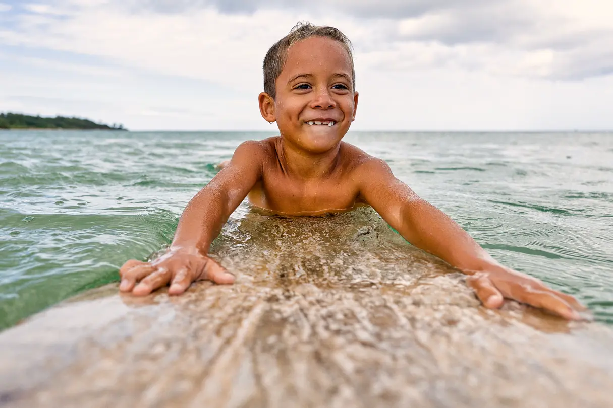 Young boy having fun on a surfboard