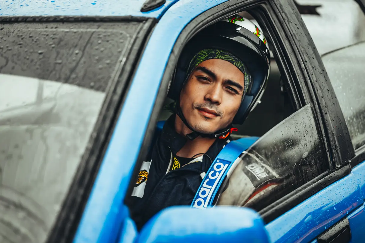 Racing driver in a blue car