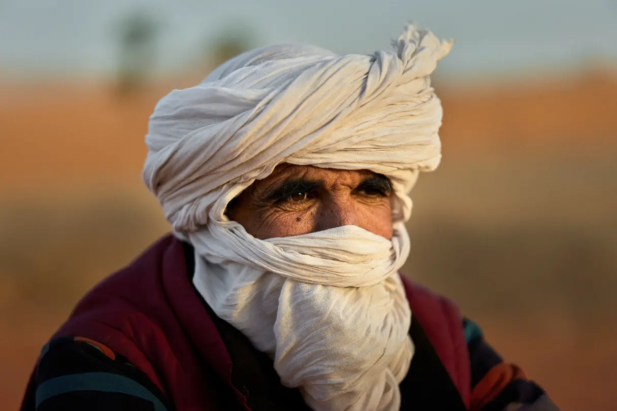 Portrait of an old man with a white cloth drawn over his face