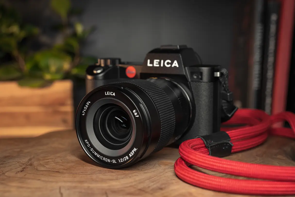Leica SL camera with the APO-Summicron-SL 28 and a red strap
