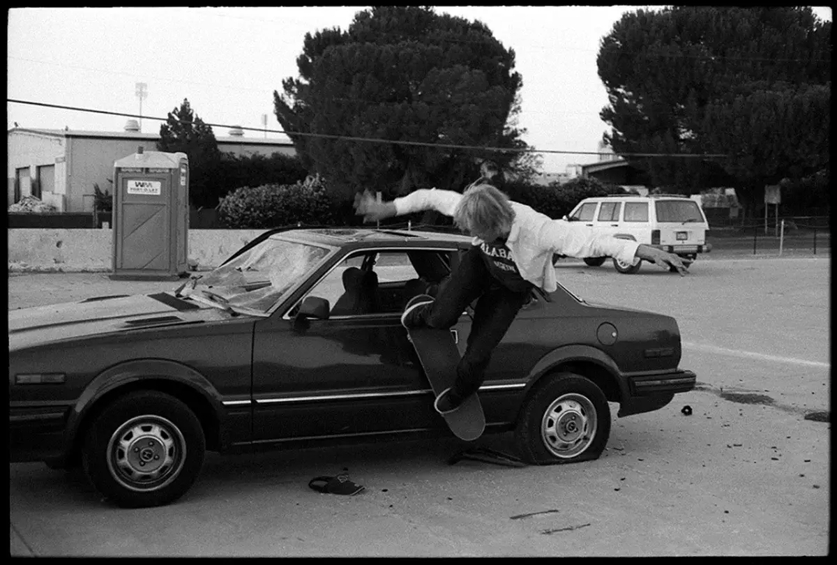 sakteboarder jumping from car b&w