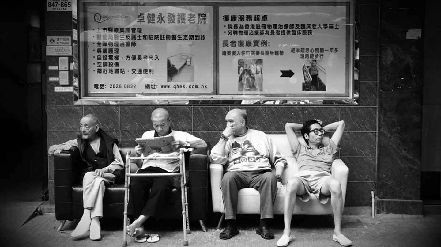 men sitting on bench b&w