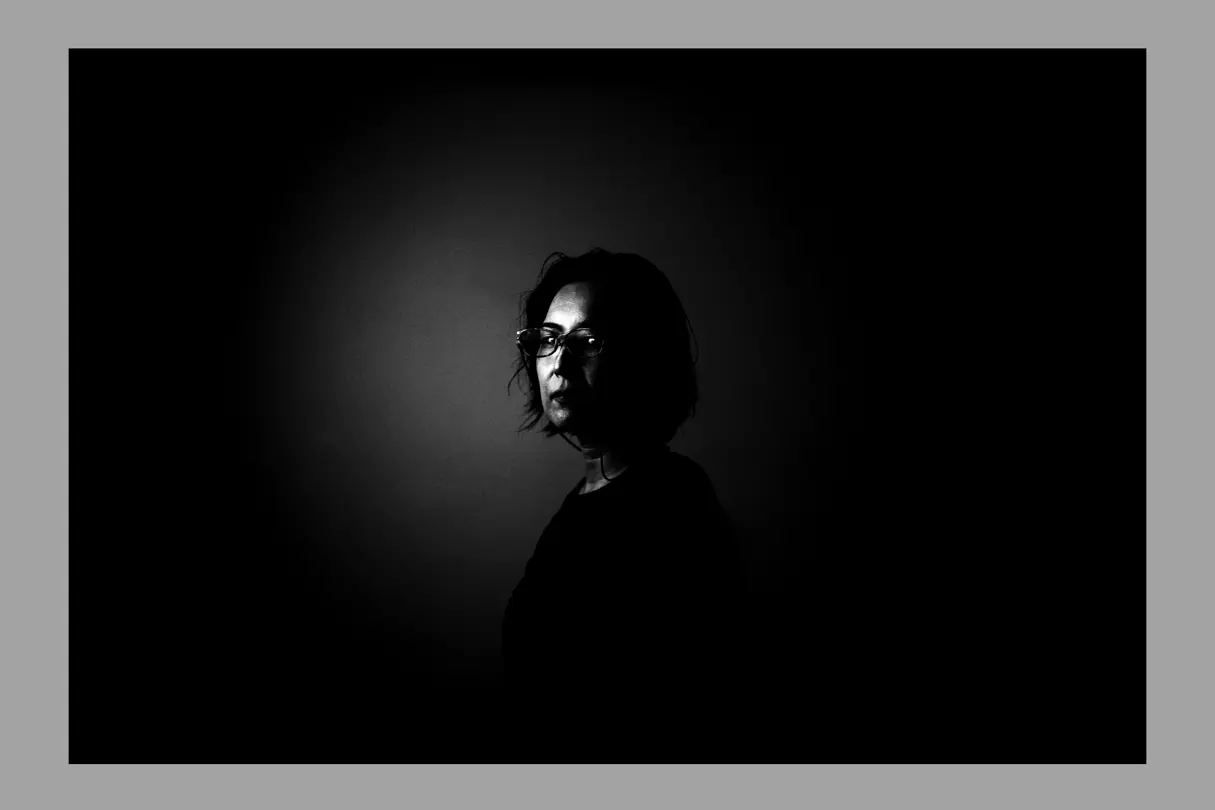 woman in black and infront of a black background