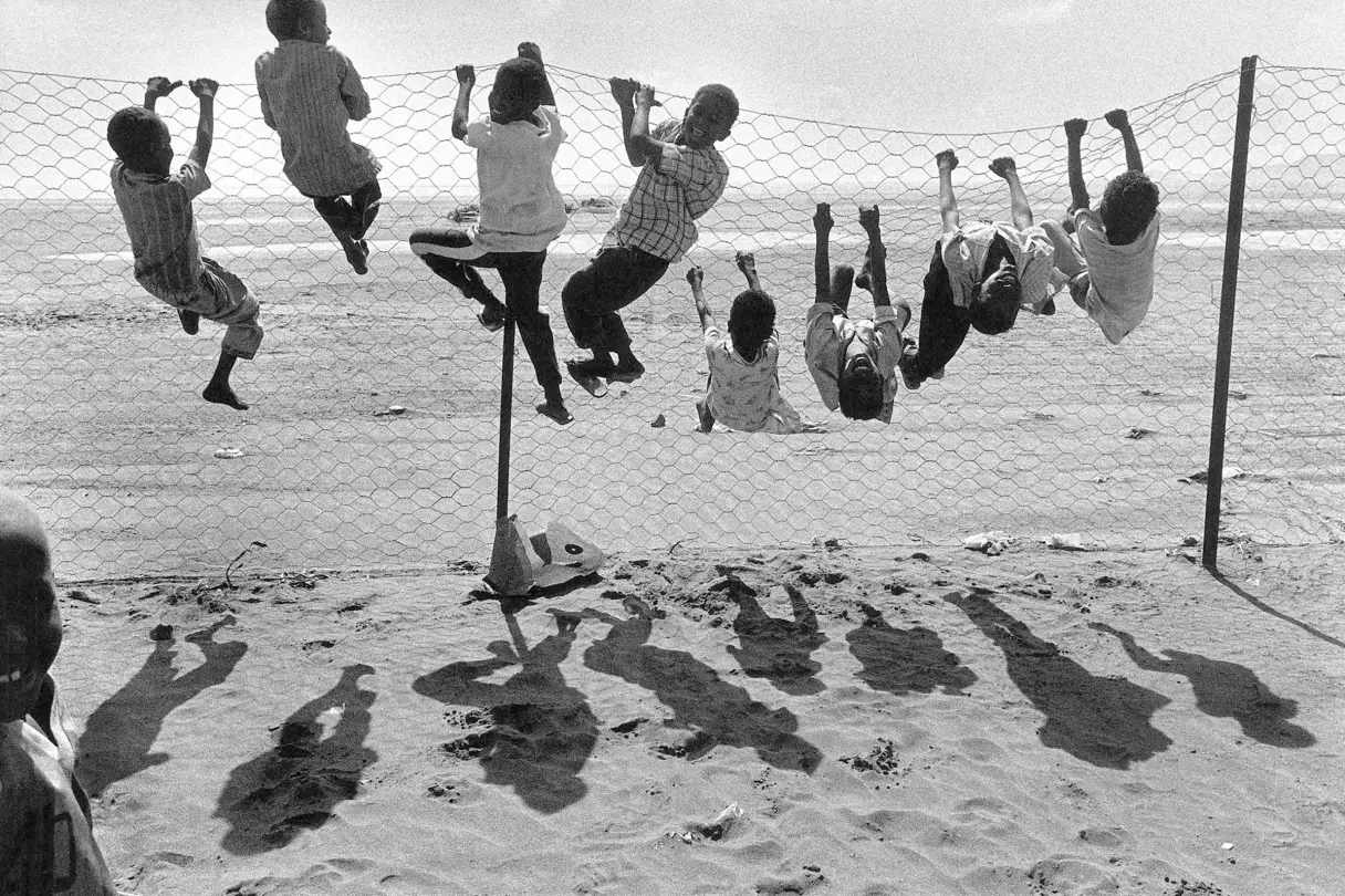 children playing with fence b&w