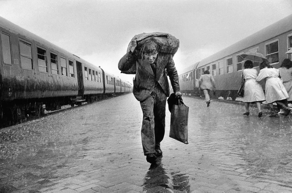 man walking through rain b&w