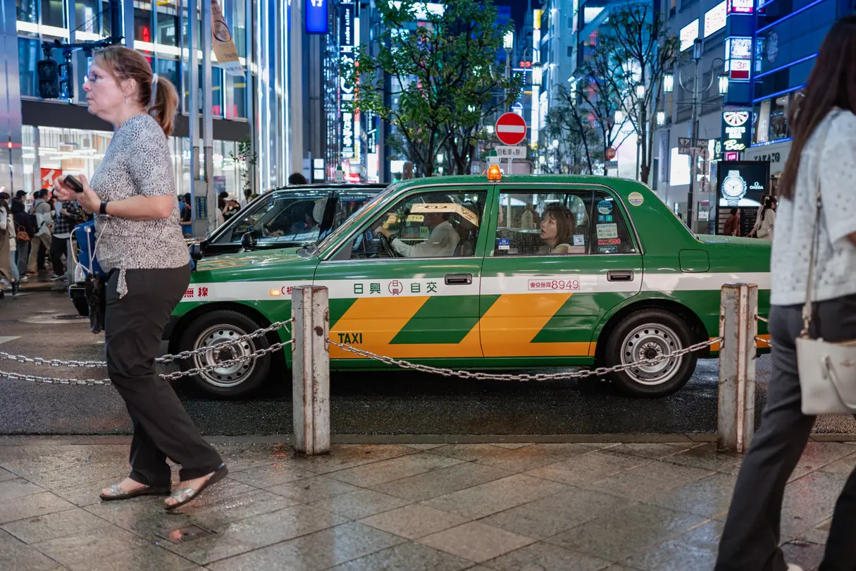 Green taxi in road traffic