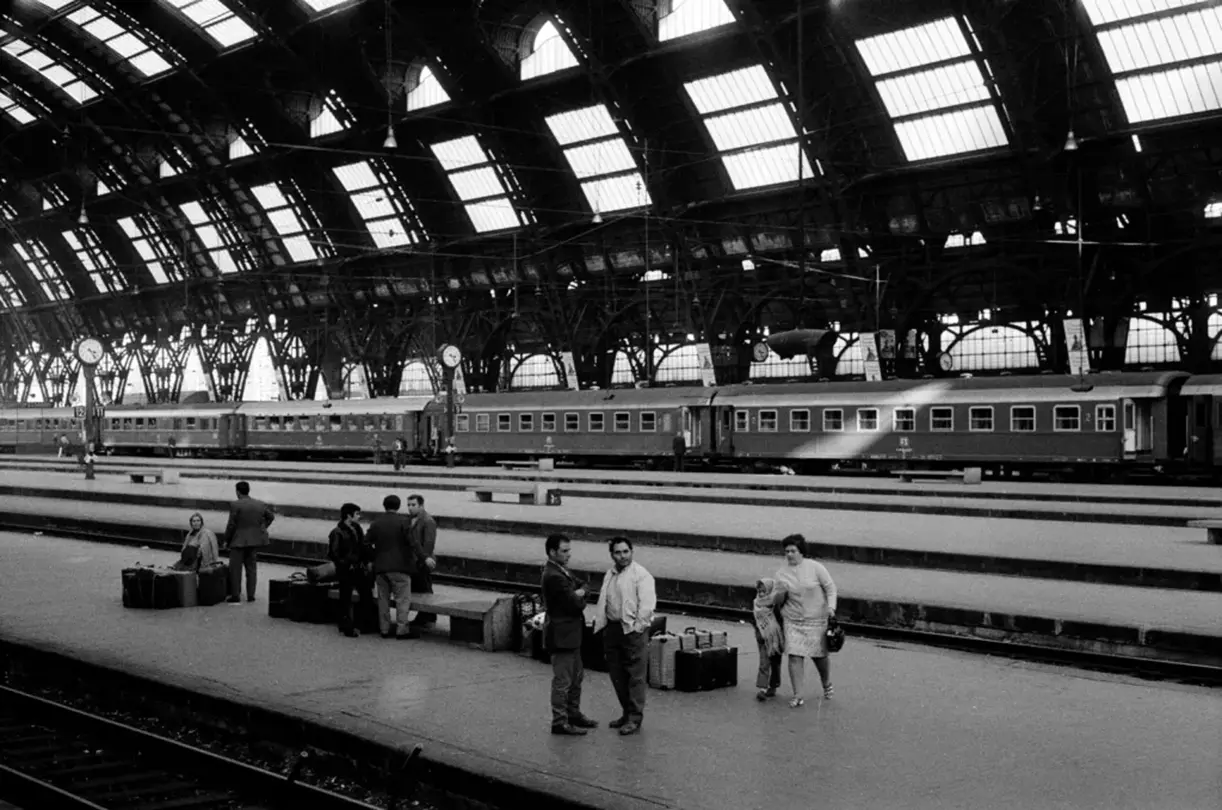 people at the train station b&w