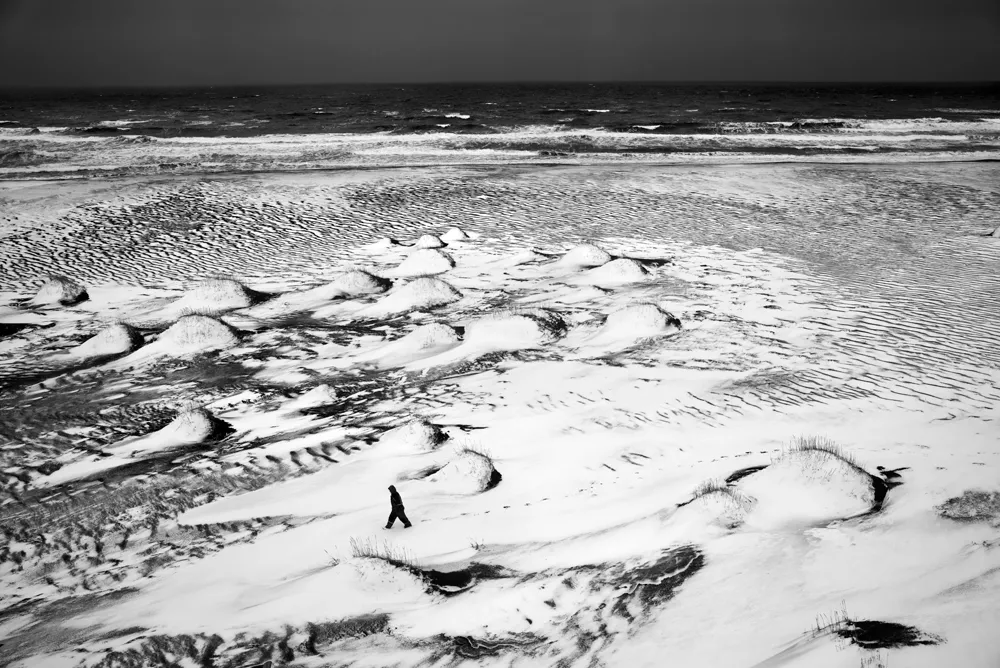 snowy landscape with a person b&w