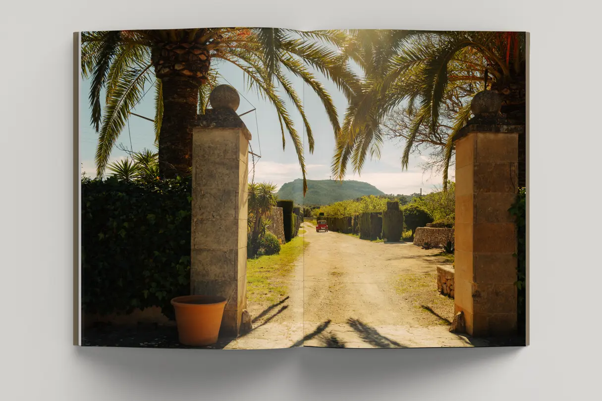 A small red car drives through the Mallorcan countryside