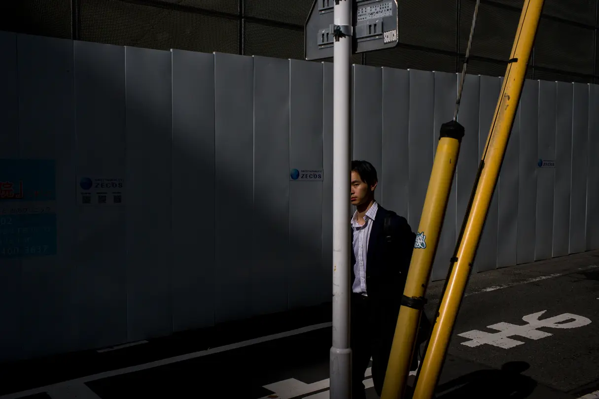 A man is out for a walk on his own in Tokyo