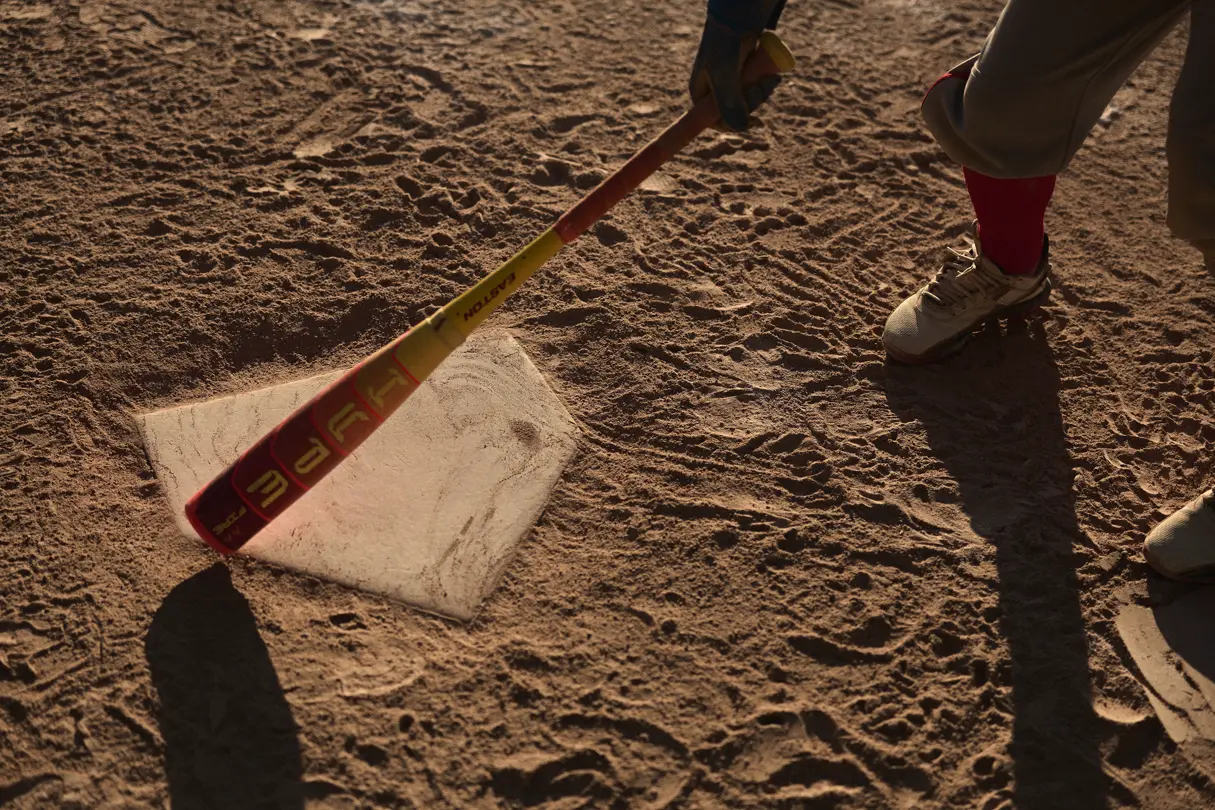 A close-up of a baseball bat being held in a hand