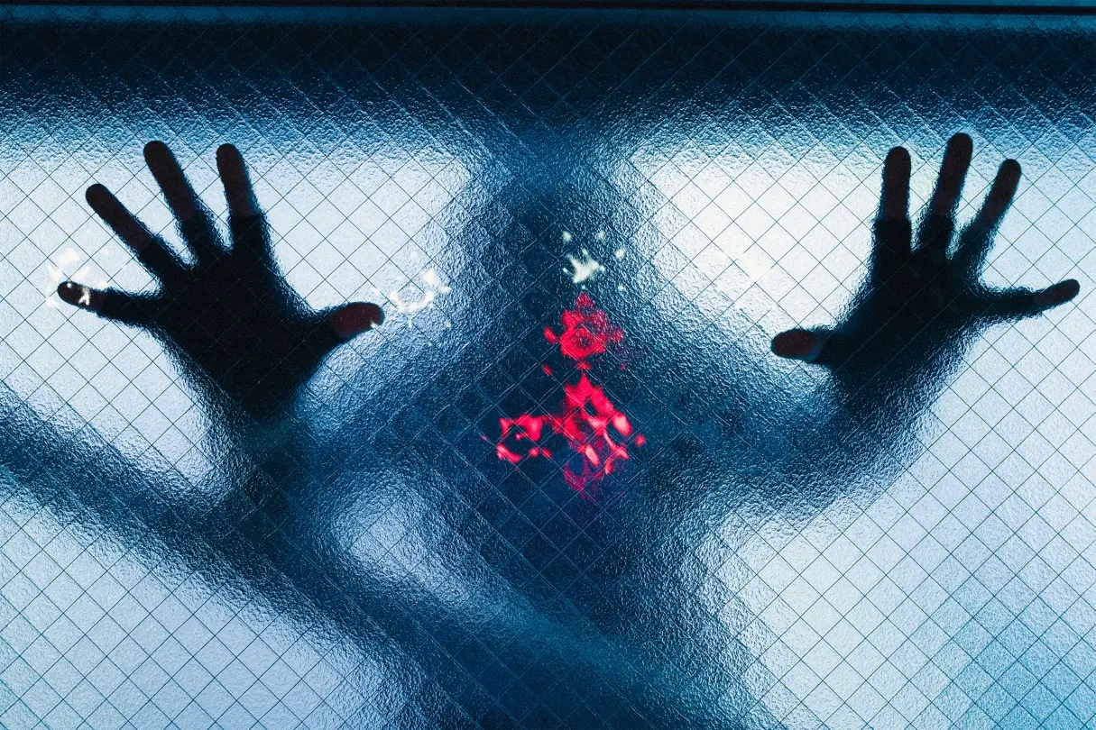 Ombre d'une personne derrière une vitre