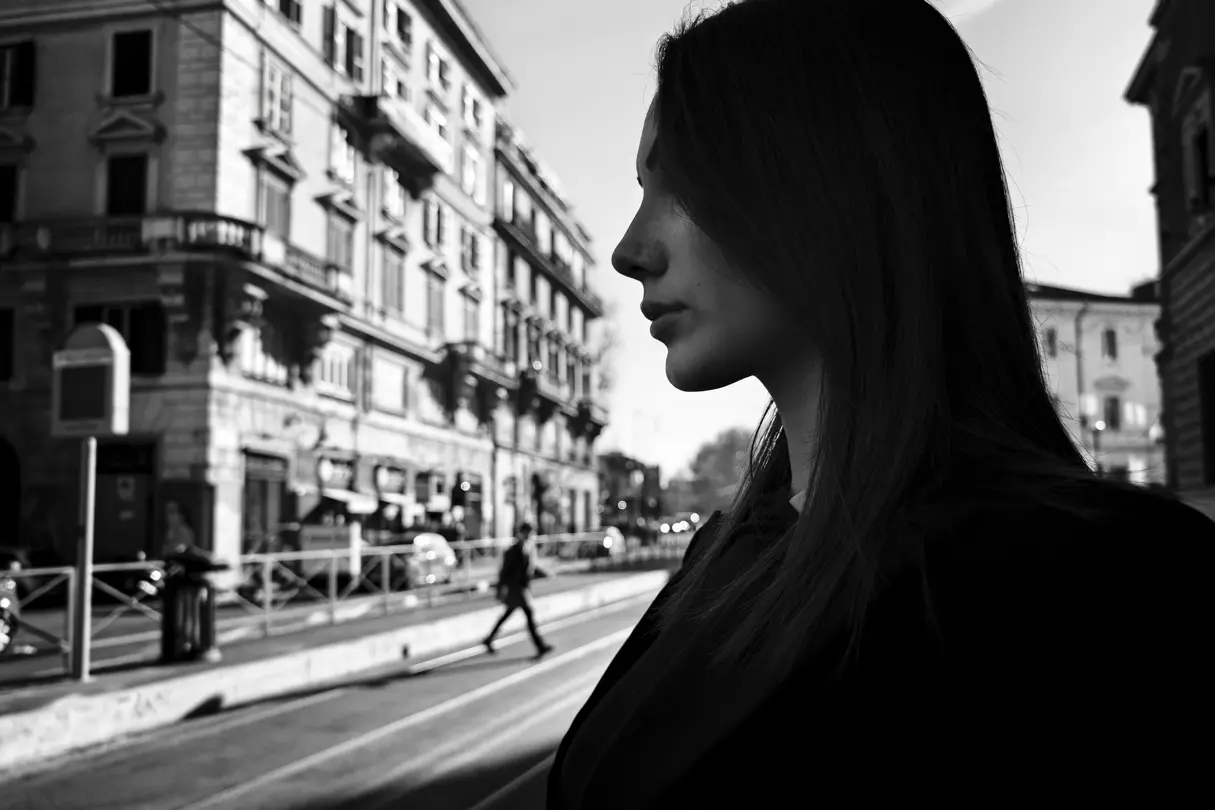 black-and-white photograph, portrait of a woman and the city in the backround