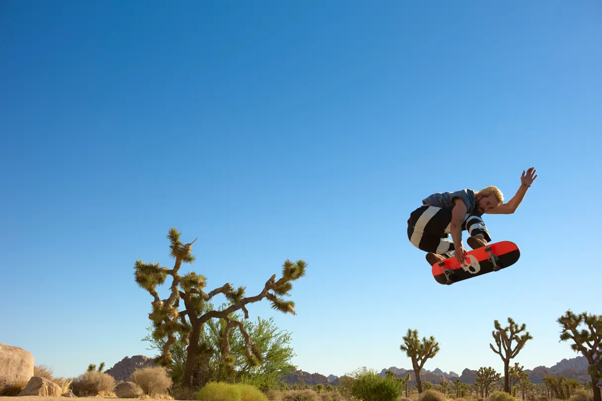 Skateboarder jumping in the Joshua Tree National Park
