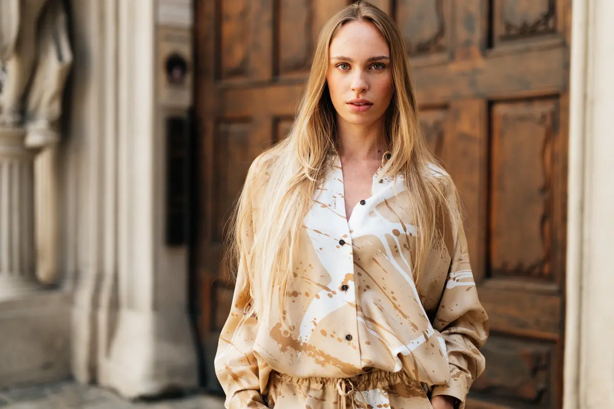 Portrait of a young blonde woman with a beige blouse