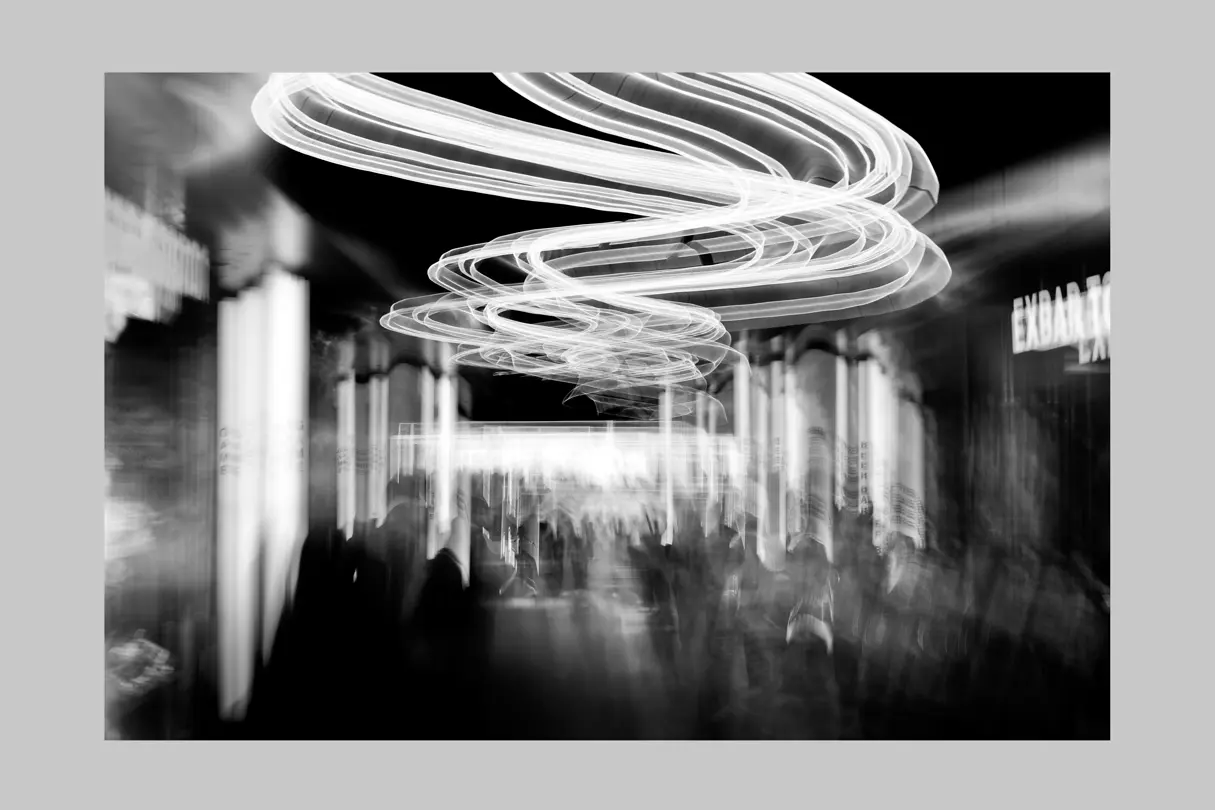 Abstract light trails and a crowd in Tokyo captured with creative long-exposure black-and-white photography.
