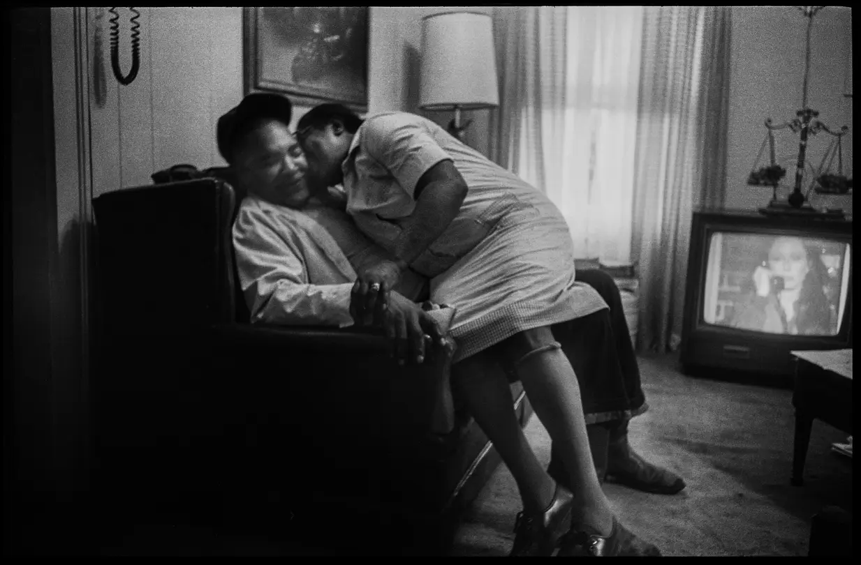 Cully and James sharing a quiet moment at home in Arkansas. Analog black-and-white photograph from Lisa McCord’s multi-generational project “Rotan Switch.”