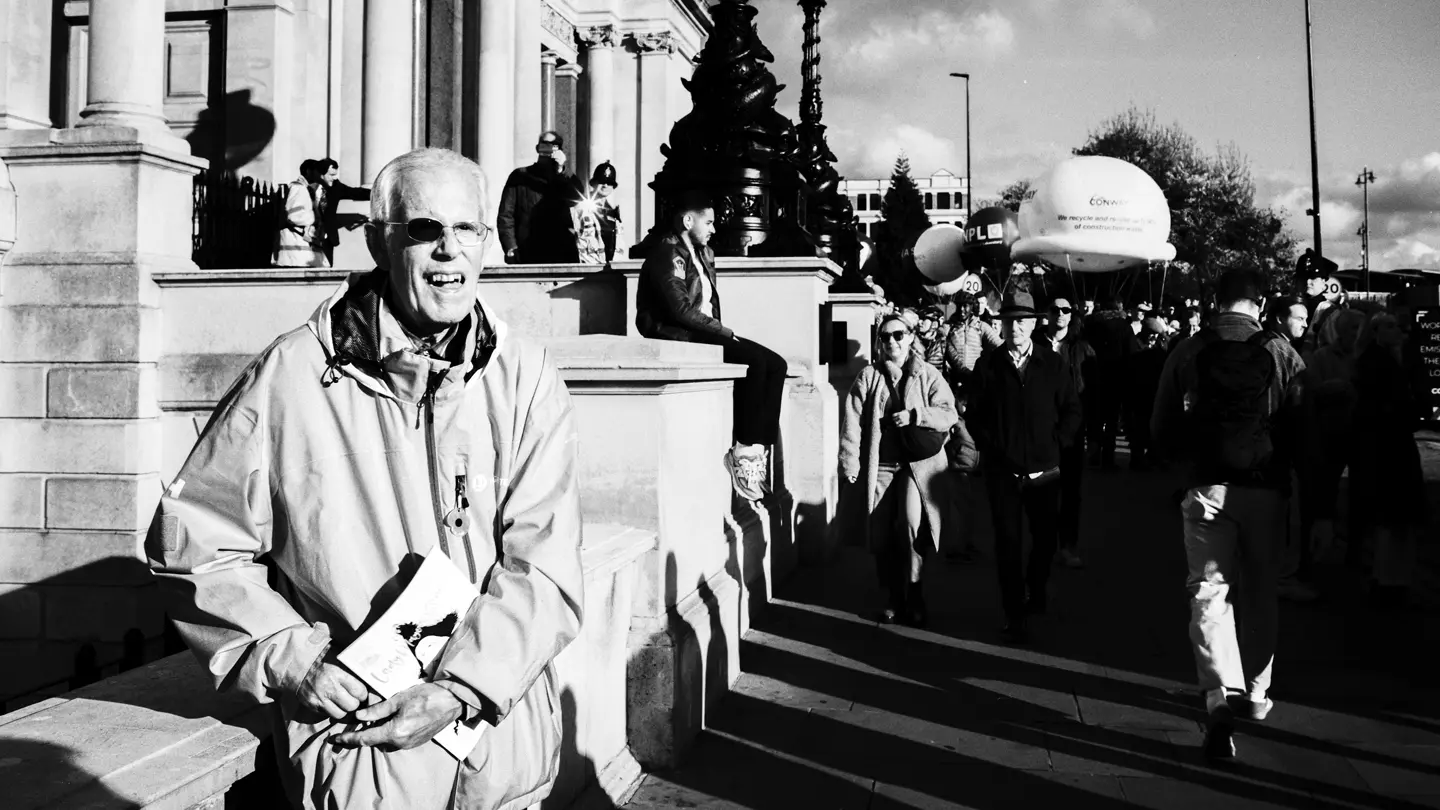 Black and White photo of man with eyepiece missing from glasses.