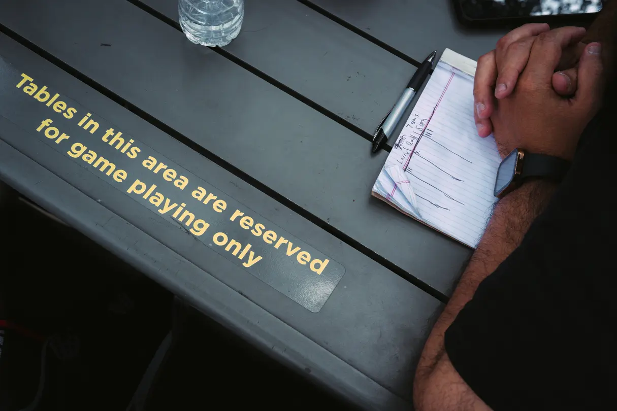 Reserved chess table with a score sheet in a public park.