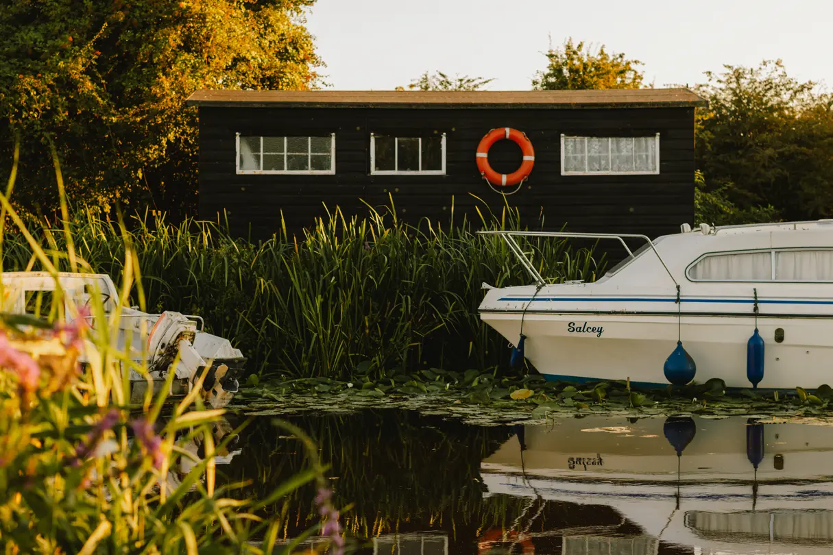 Two small motorboats on a green lake