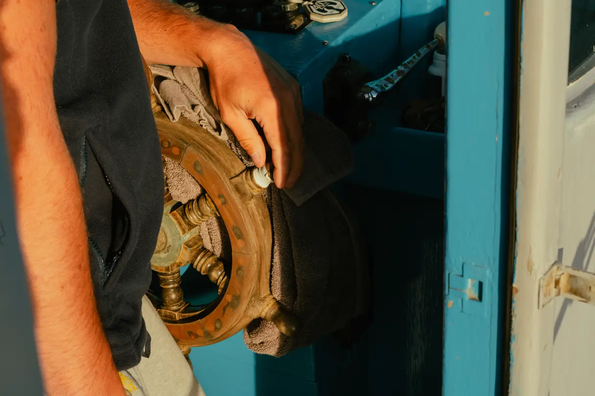 Close-up of an old steering wheel on a sailboat
