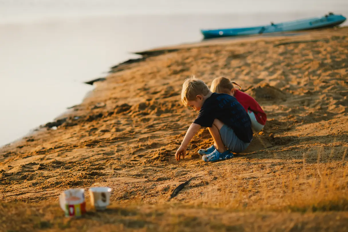 A boy and a girl playing on the beach