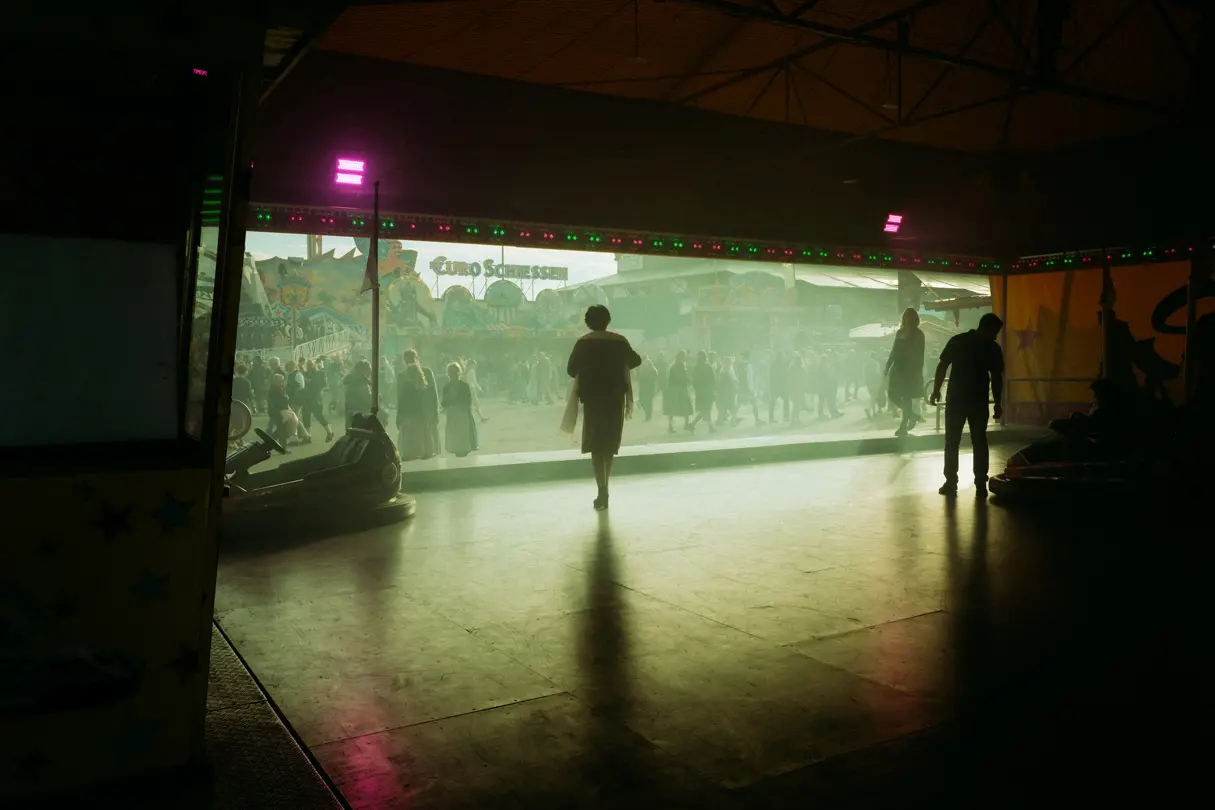 Silhouettes of visitors at a bumper car ride during Munich Oktoberfest.