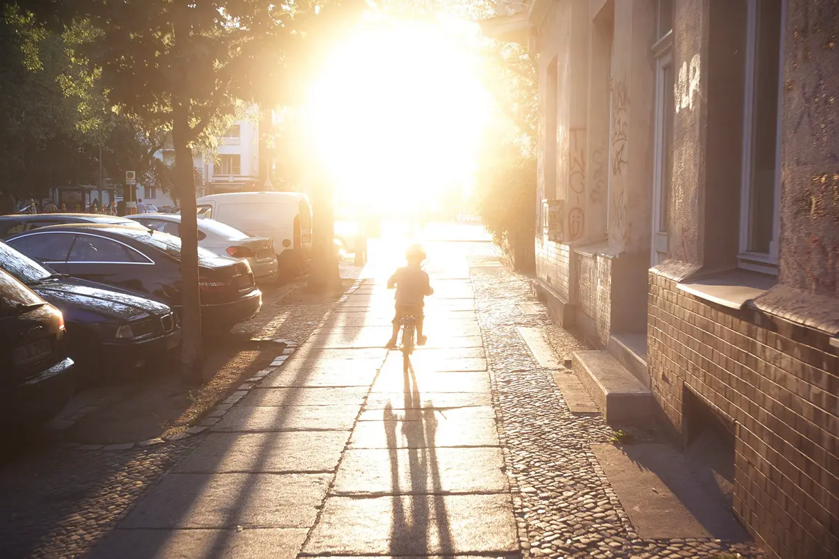 Child on a bike in sunlight 