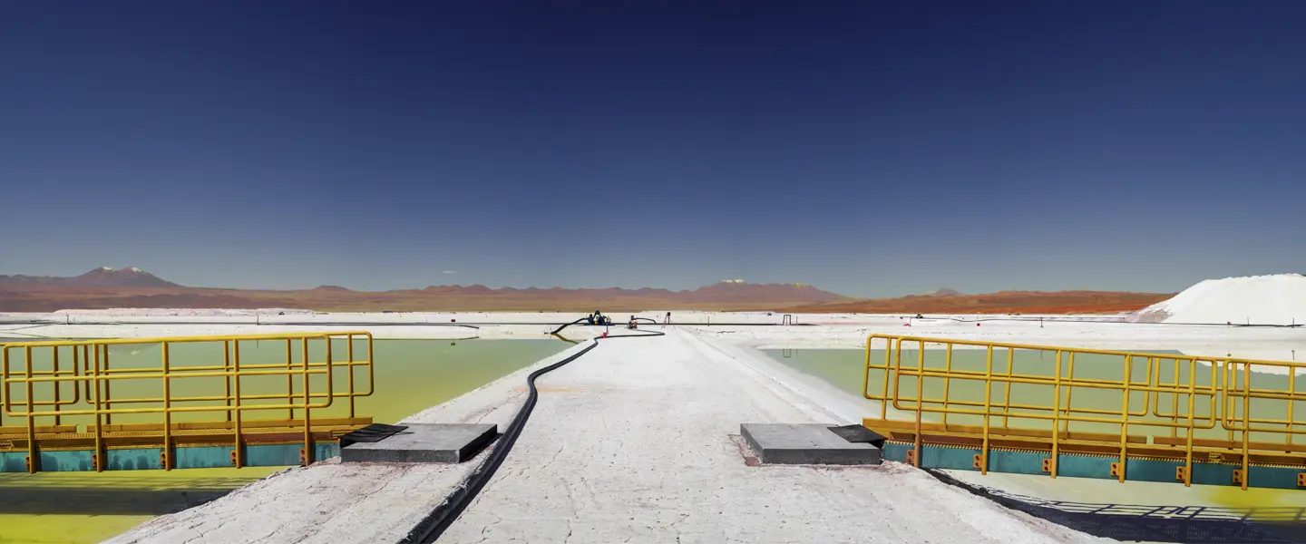 LOBA Winner 2024 image: Salt evaporation ponds surrounded by a vast desert and distant mountains.