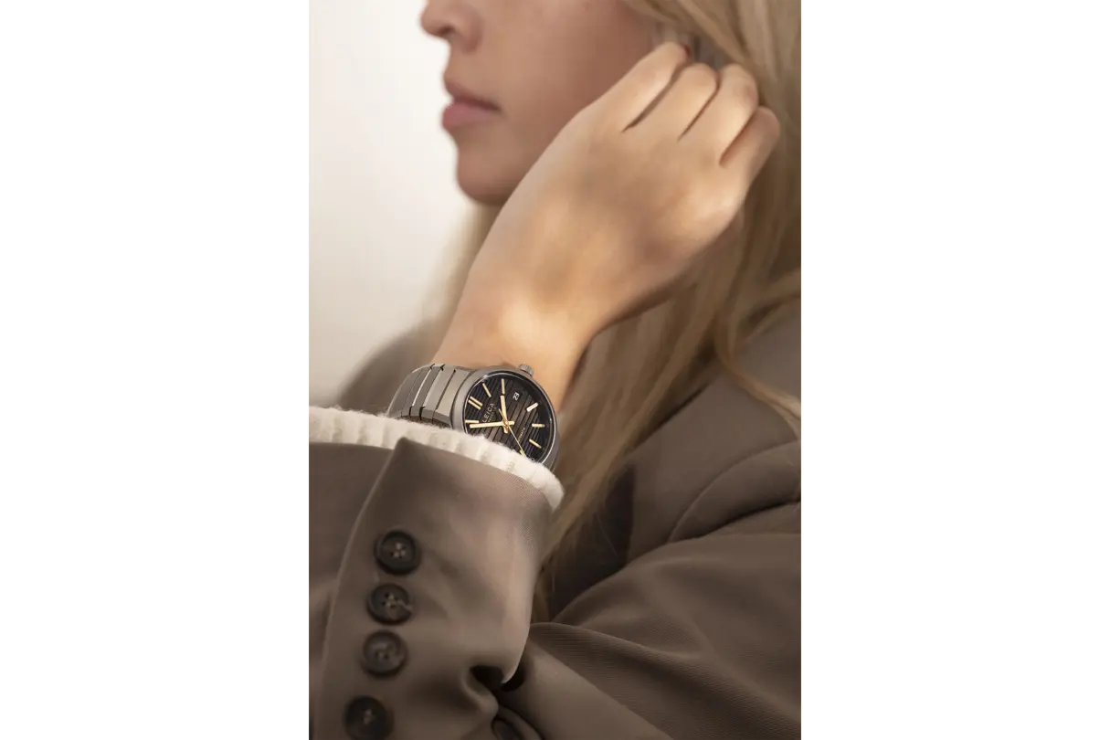 A woman wearing a Leica watch.