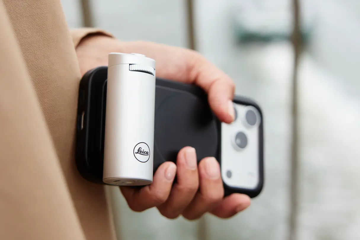 Close-up of a white Leica LUX grip attached to a black phone